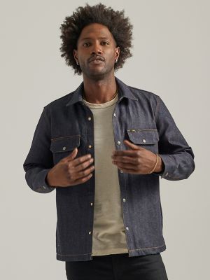 Man wearing a denim overshirt, white T-shirt and white pants with