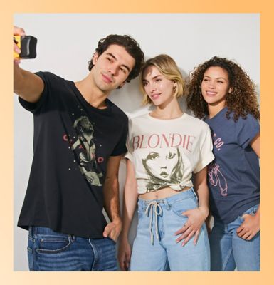 Friends wearing Lee tees standing against a wall.