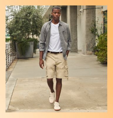 Friends wearing Lee utility standing against a wall.
