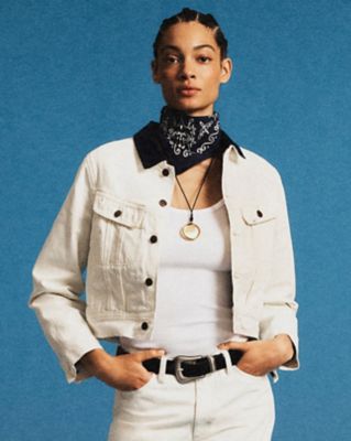 Folded Lee × J.Crew denim pieces arranged on a clean neutral backdrop.