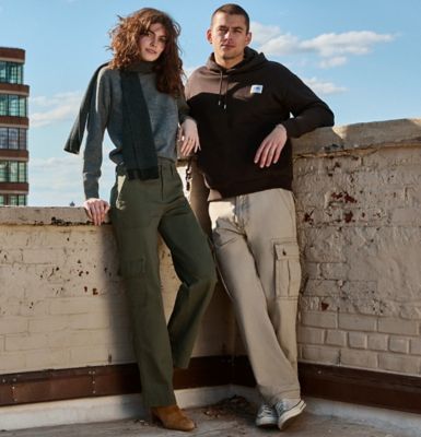 Couple on rooftop wearing cargo pants from Lee.